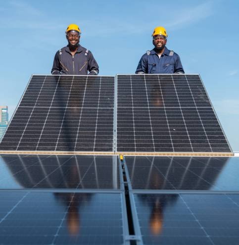 Engineers and technicians check drawings for installing solar cell panels on the roof. alternative energy energy from the sun