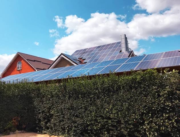 solar-panels-on-countryside-house-with-green-fence-2025-02-24-17-50-36-utc